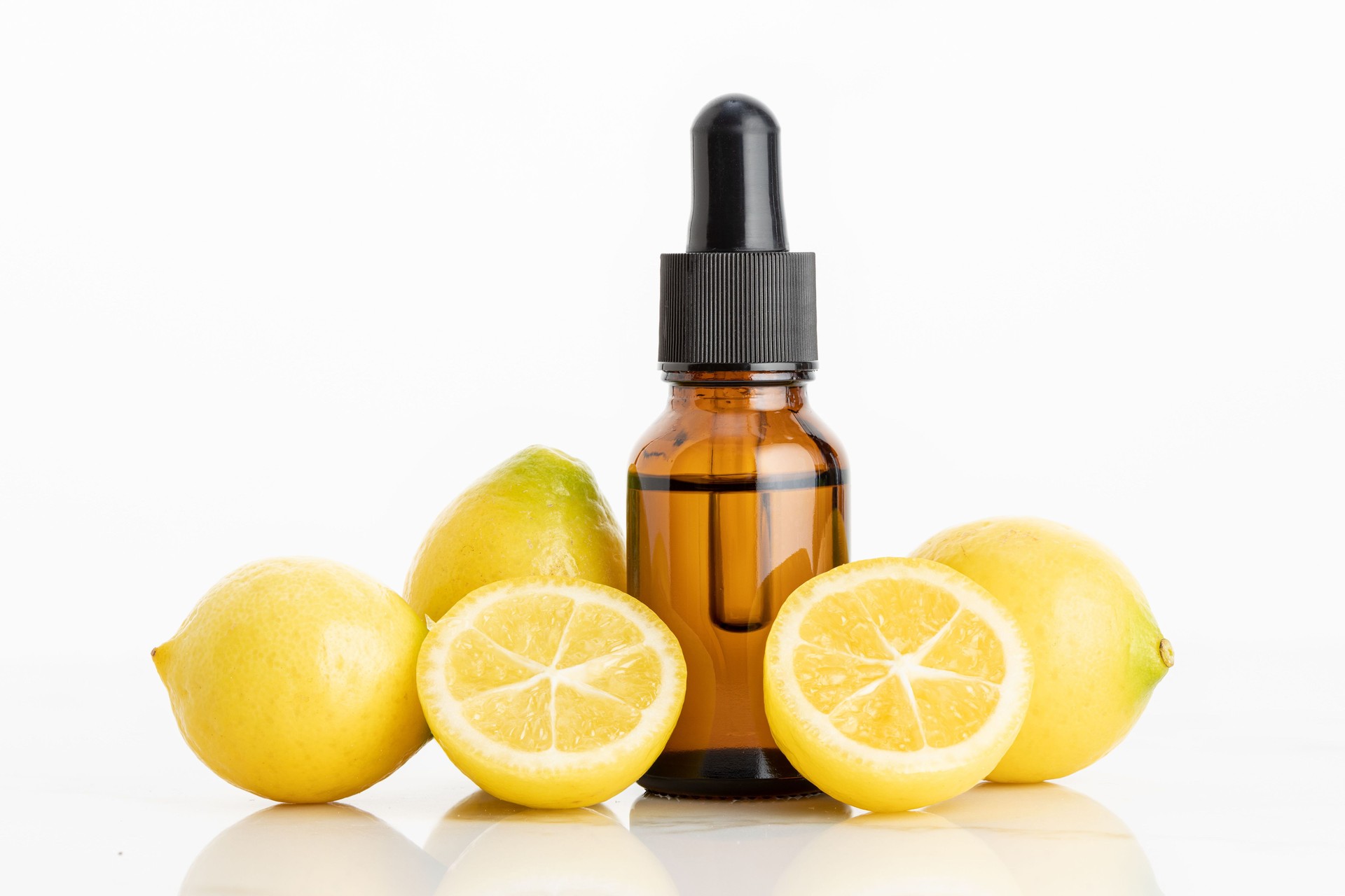 Lemon essential oil on white background
