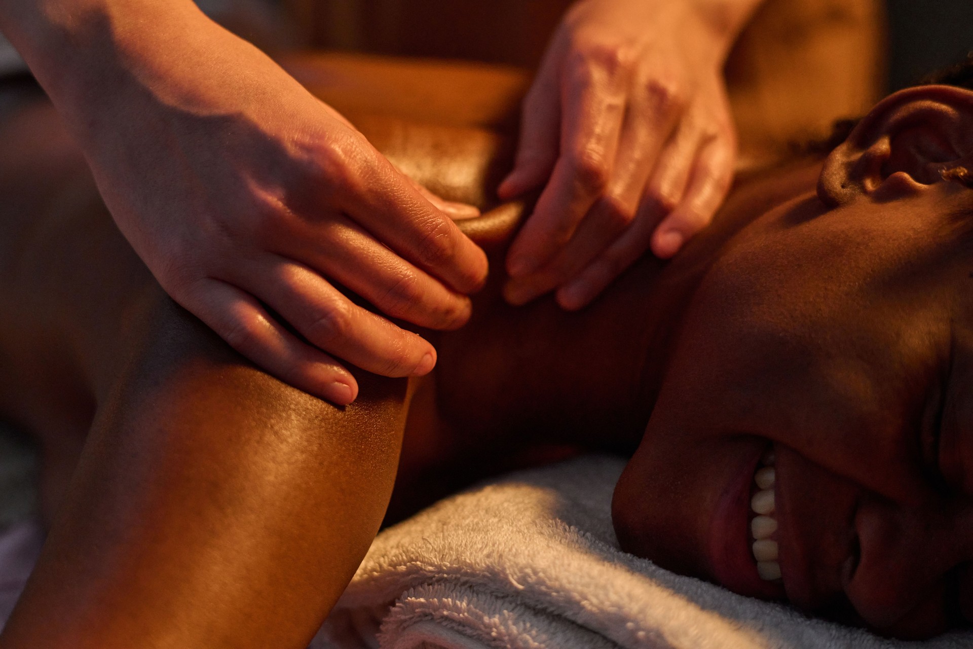 Unrecognizable Masseuse Using Petrissage Technique